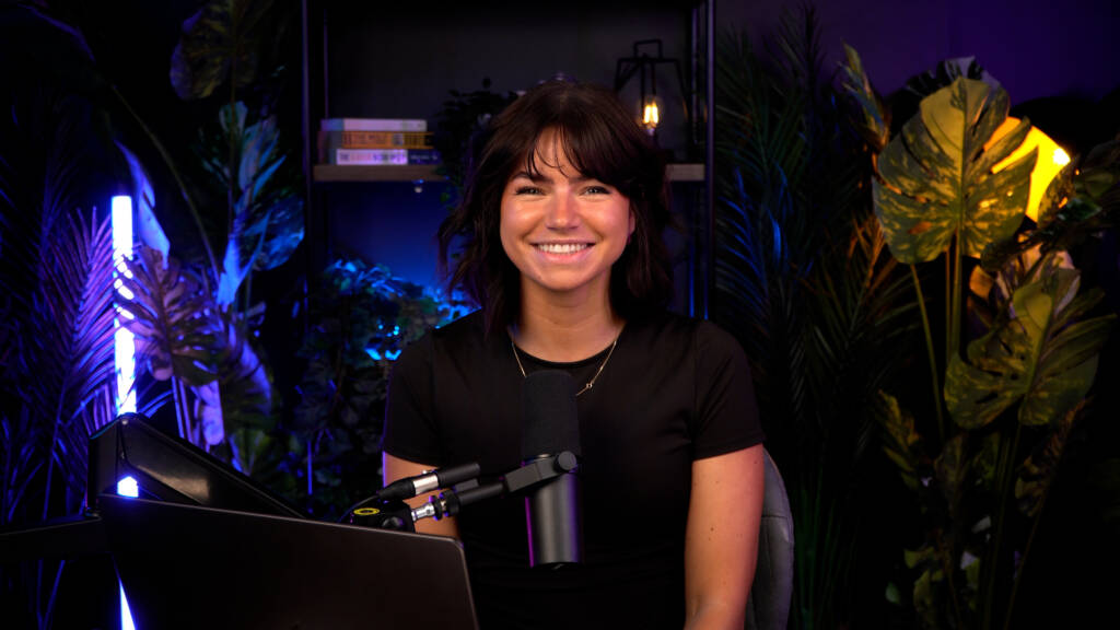 YouTube and or influencer is in a content studio smiling at the camera before she records her social media content that will be edited and published to social medias